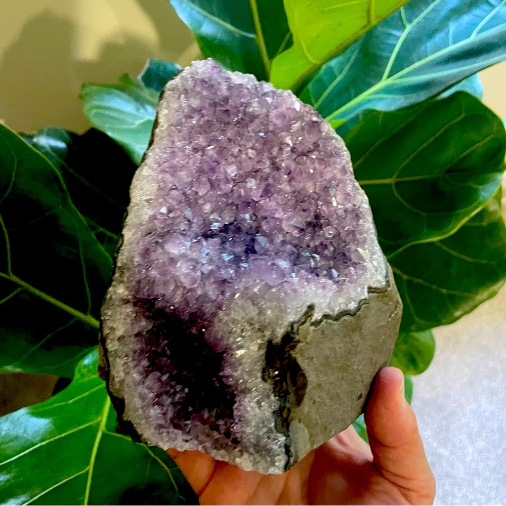 Purple amethyst self standing cut base display. Crystal geode.